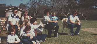 <Family sitting outside watching the action in the water.>