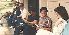 <Family sitting out by the garage.>